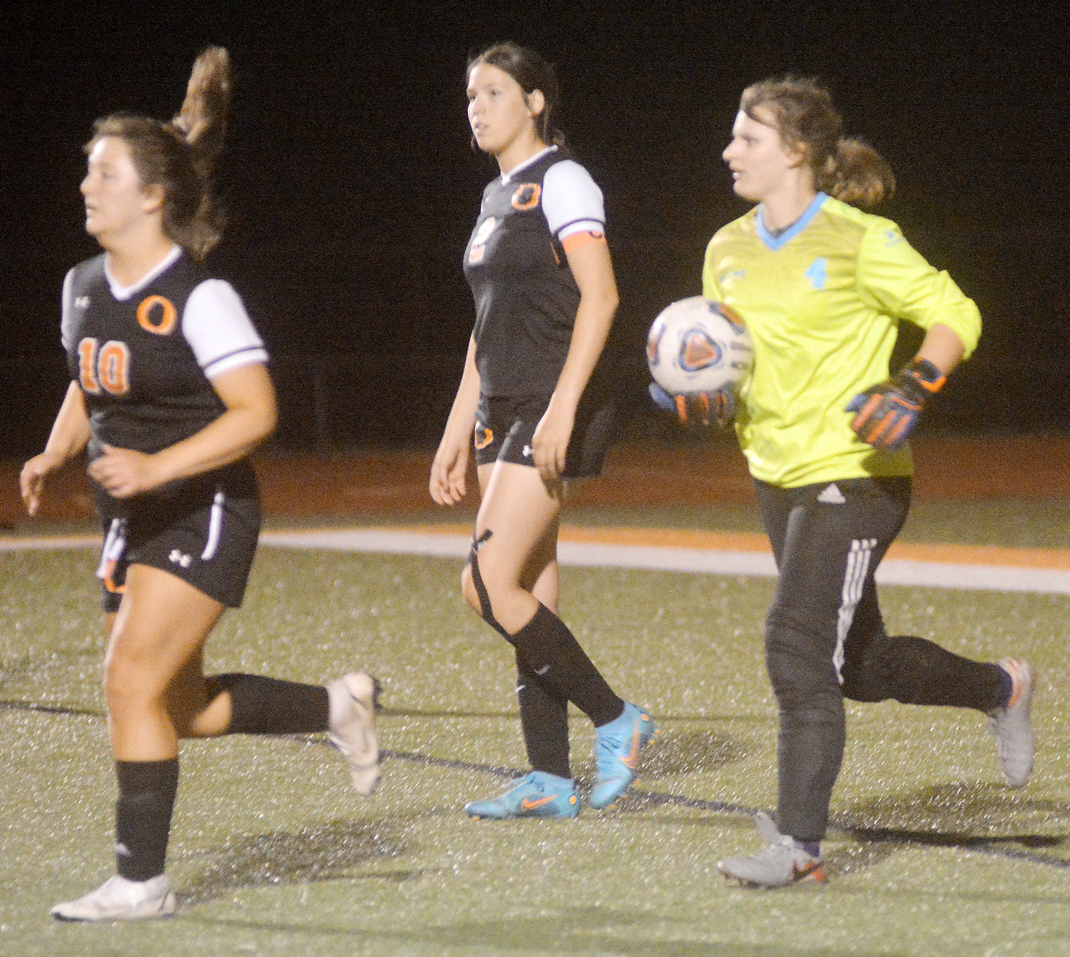 Paige Loyd (far right) prepares to kick the soccer ball down field in the Owensville Tournament championship match against Sullivan’s Lady Eagles.